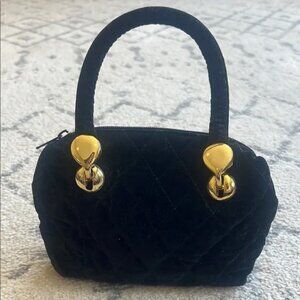 Luxurious Black and Gold Mini Bag with Structured Design